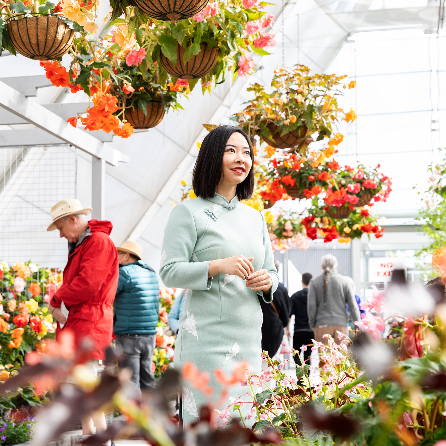 woman standing amongst flower display